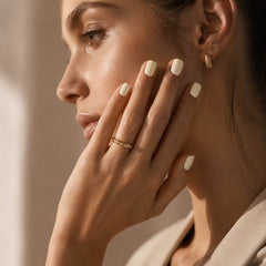 Female model wearing Nailora Vanilla Cloud Glossy Square Press-On Nails with creamy vanilla white color, short square shape, glossy finish, elegant minimalist manicure for everyday style