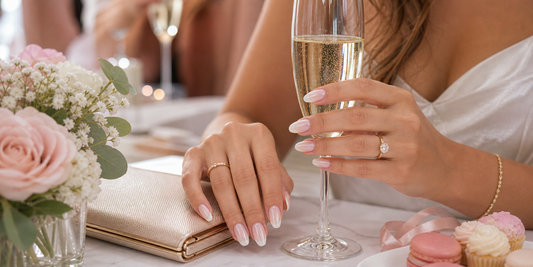 Glossy French press-on nails holding champagne at a bachelorette party