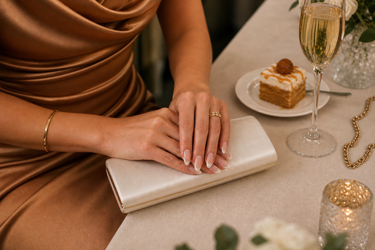 Nude French almond press-on nails styled with a caramel wedding guest dress