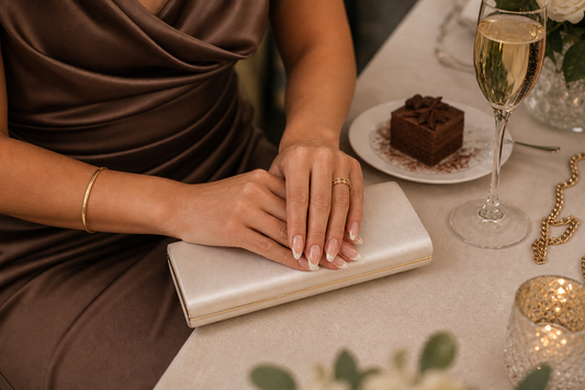 Nude French almond press-on nails styled with a cocoa wedding guest dress