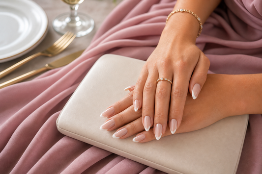 Nude French almond press-on nails styled with a dusty rose wedding guest dress