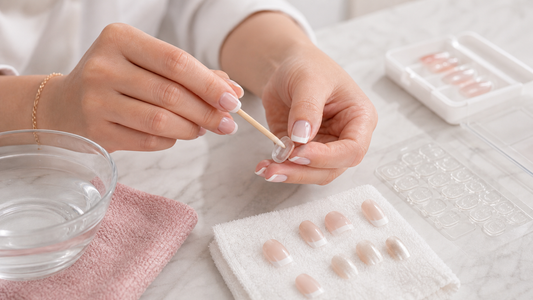 Cleaning adhesive residue from reusable press-on nails after removal