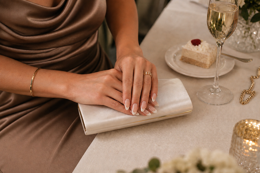 Nude French almond press-on nails styled with a mocha wedding guest dress
