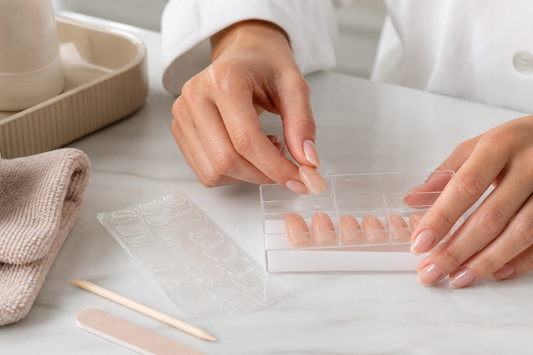 Reusable press-on nails stored after gentle removal with jelly adhesive tabs, nail file and cuticle stick