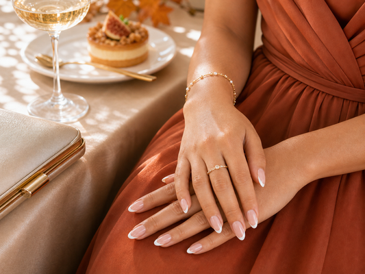 Nude French almond press-on nails styled with a rust wedding guest dress