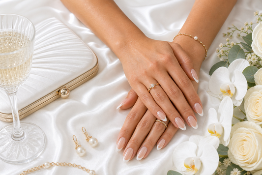 Warm nude French almond press-on nails styled with a snow white wedding guest dress