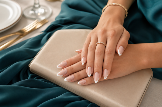Nude French almond press-on nails styled with a teal wedding guest dress