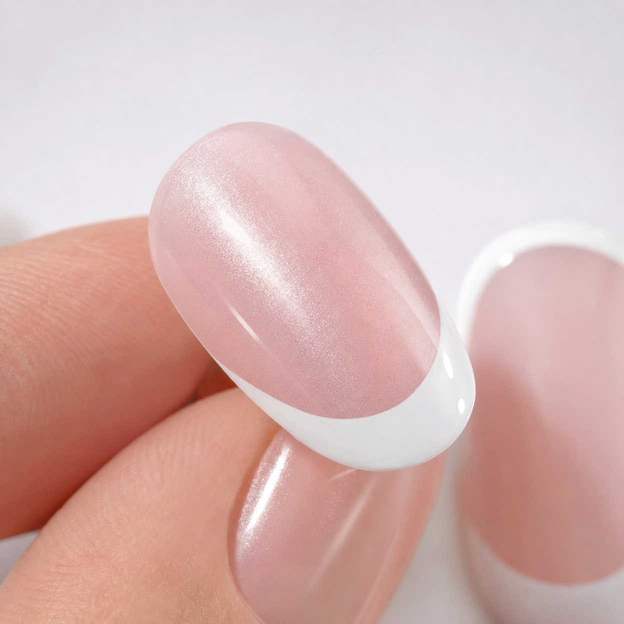Close-up of Blush Veil short square blush pearl French press-on nails showing soft pink glossy finish