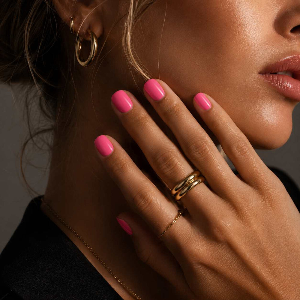 Female model wearing Nailora Bubblegum Pink Glossy Square Press-On Nails featuring vibrant pink tones and elegant square-shaped manicure style