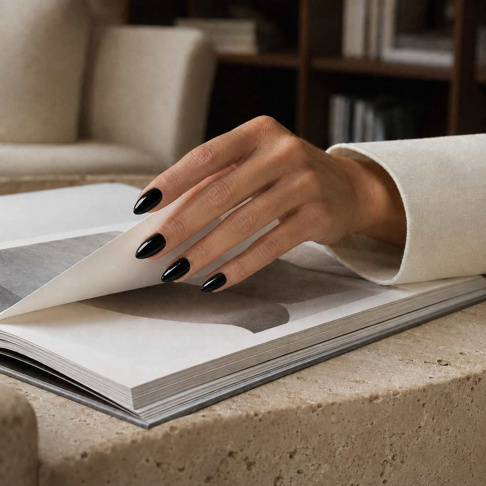 Nailora Jet Black Glossy Short Almond Press-On Nails featuring a rich black shade with a reusable salon-quality finish for everyday wear, evening style, and modern minimalist fashion.