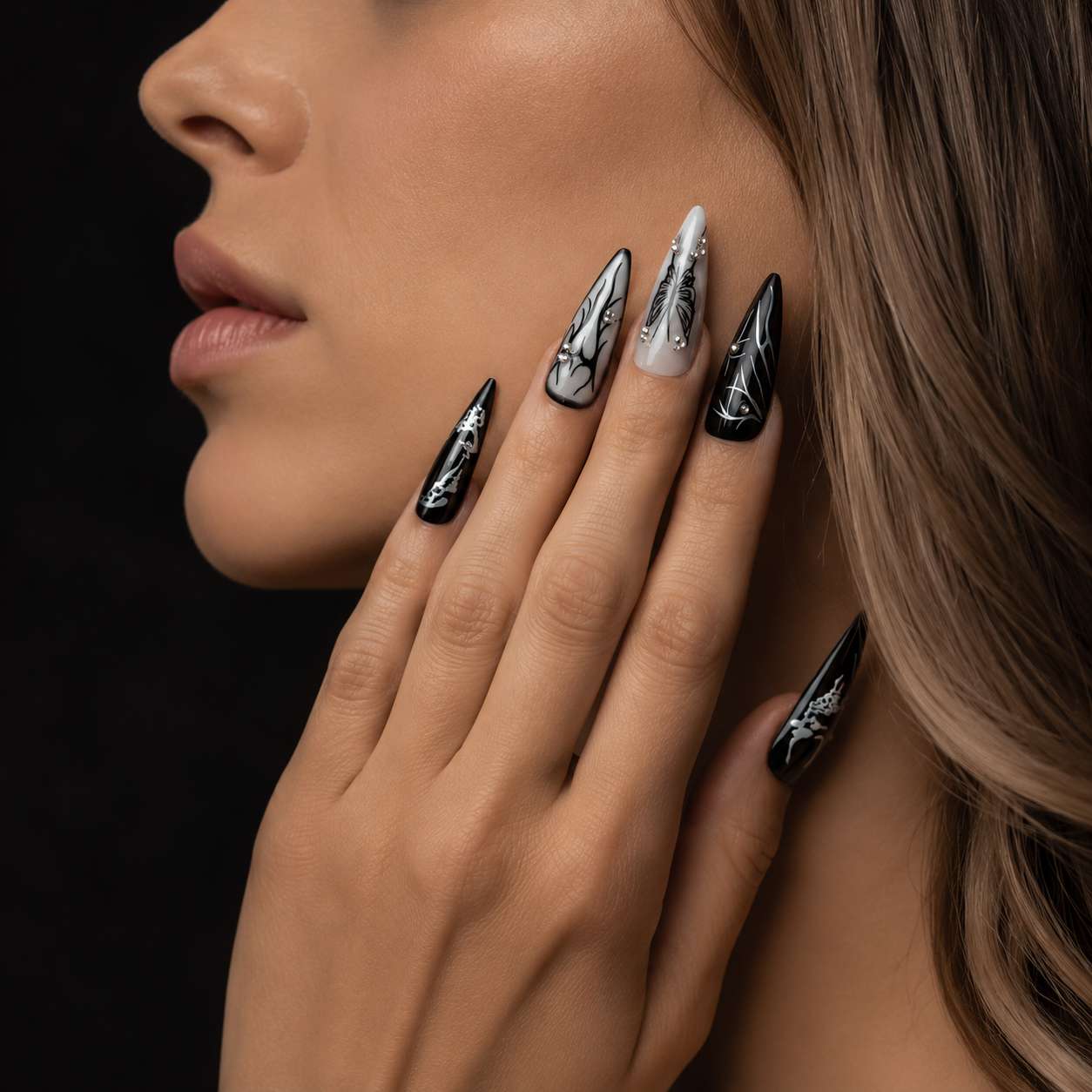Elegant hand wearing gothic press-on nails styled in dark aesthetic fashion