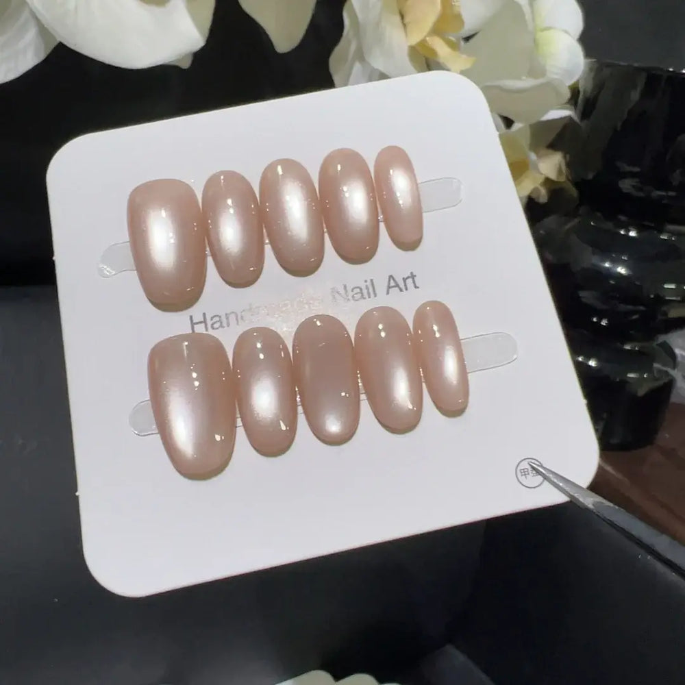 Aurora Veil Nude Cat-Eye Almond Press-On Nails applied