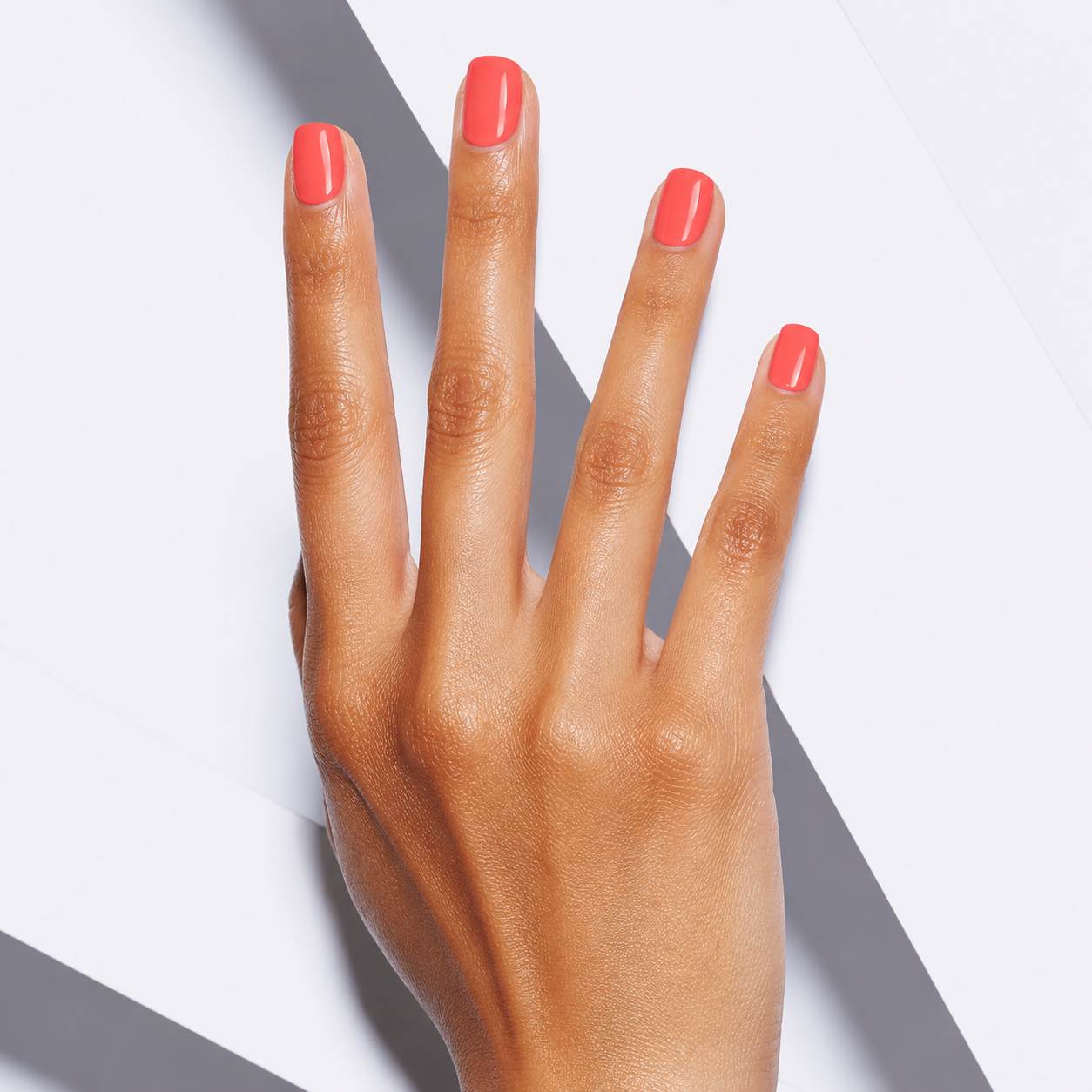 Peach Glow peach coral press-on nails styled for summer vacations and warm-weather outfits