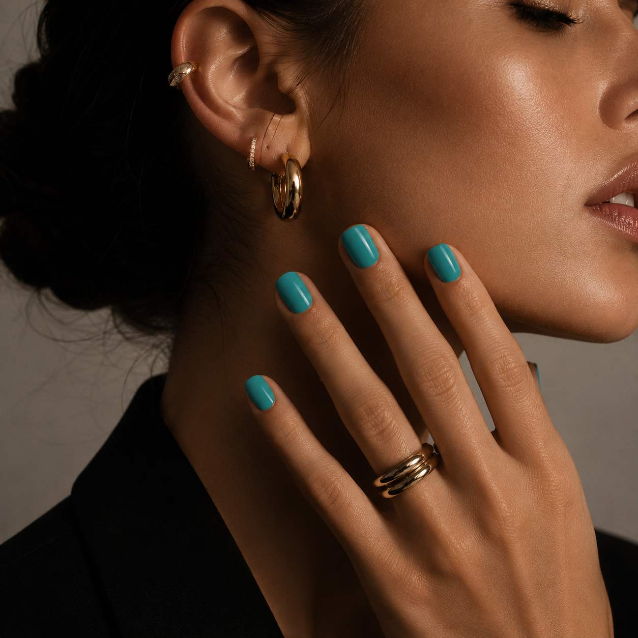 Female model wearing Nailora Turquoise Lagoon Glossy Square Press-On Nails featuring vibrant turquoise tones and elegant square-shaped manicure style