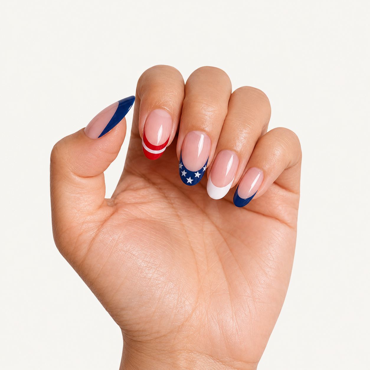 Hand wearing almond press-on nails with Liberty Stripe French tip design, elegant and natural salon look