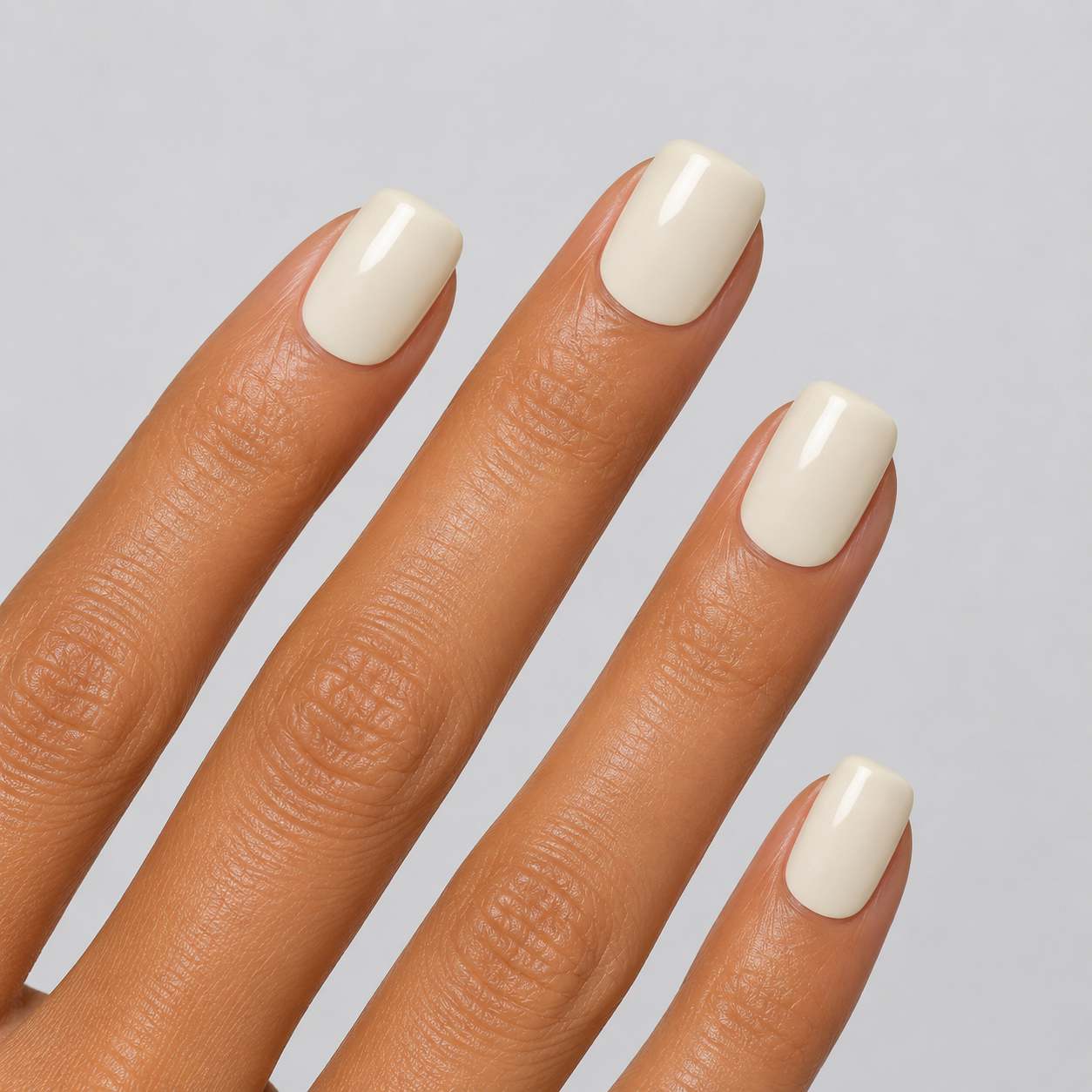 Nailora Vanilla Cloud Glossy Square Press-On Nails in creamy vanilla white, featuring a short square shape, glossy finish, reusable salon-quality design, and minimalist everyday manicure style.