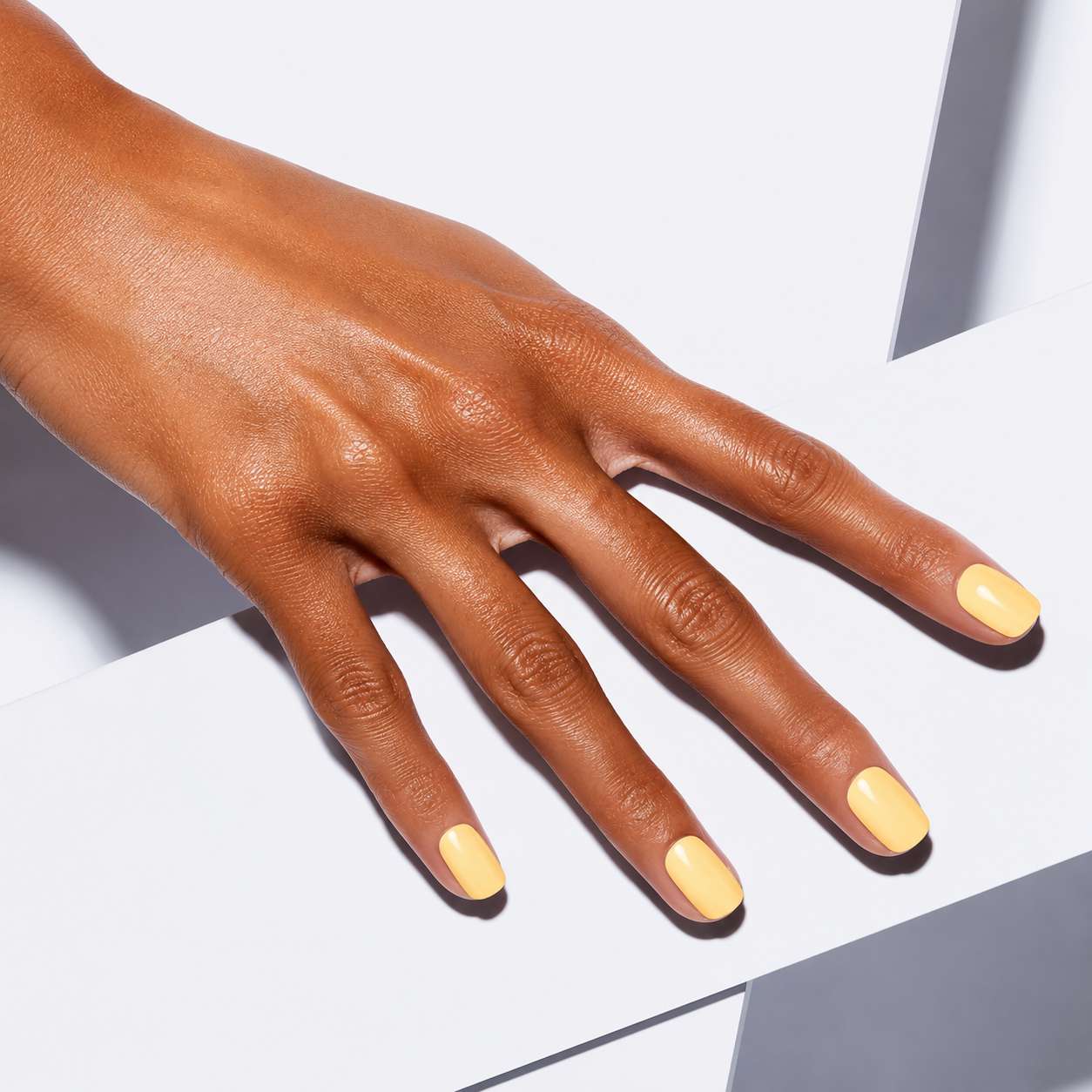 Nailora Lemon Sorbet Glossy Square Press-On Nails styled for summer elegance with fresh lemon yellow color and modern minimalist aesthetic