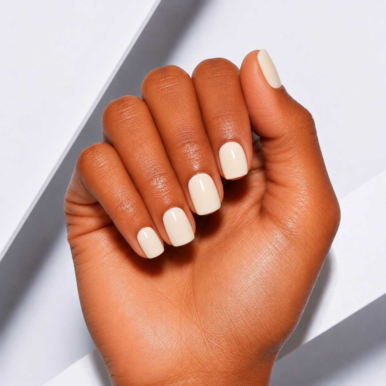 Soft vanilla white glossy square press-on nails by Nailora, featuring a short square shape, natural salon-style finish, and minimalist everyday manicure design.