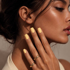 Female model wearing Nailora Lemon Sorbet Glossy Square Press-On Nails featuring cheerful lemon yellow tones and elegant square-shaped manicure style