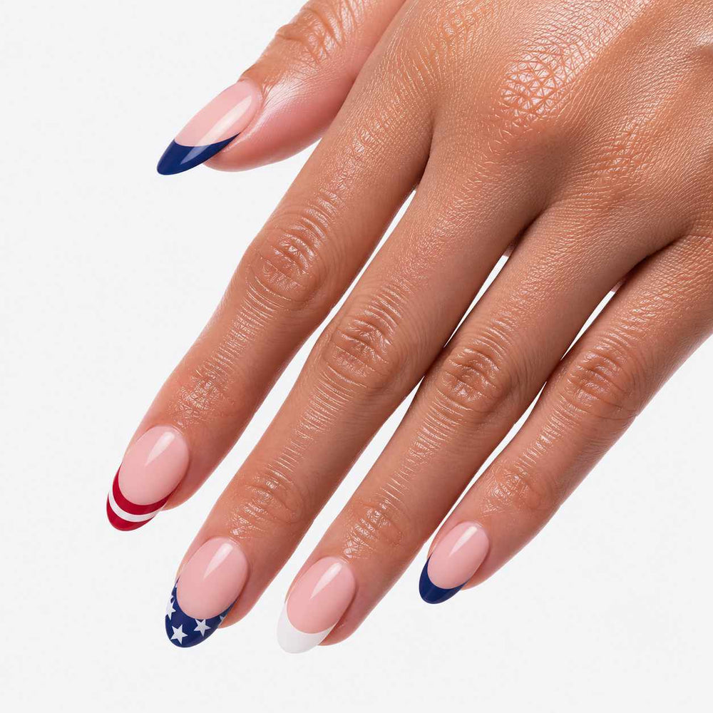 Woman showing reusable press-on nails with glossy finish and patriotic French manicure style