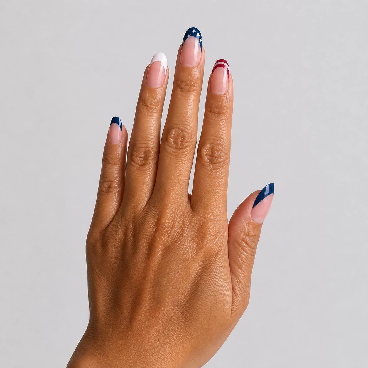 Almond-shaped press-on nails with glossy finish and patriotic stripe French tip manicure design