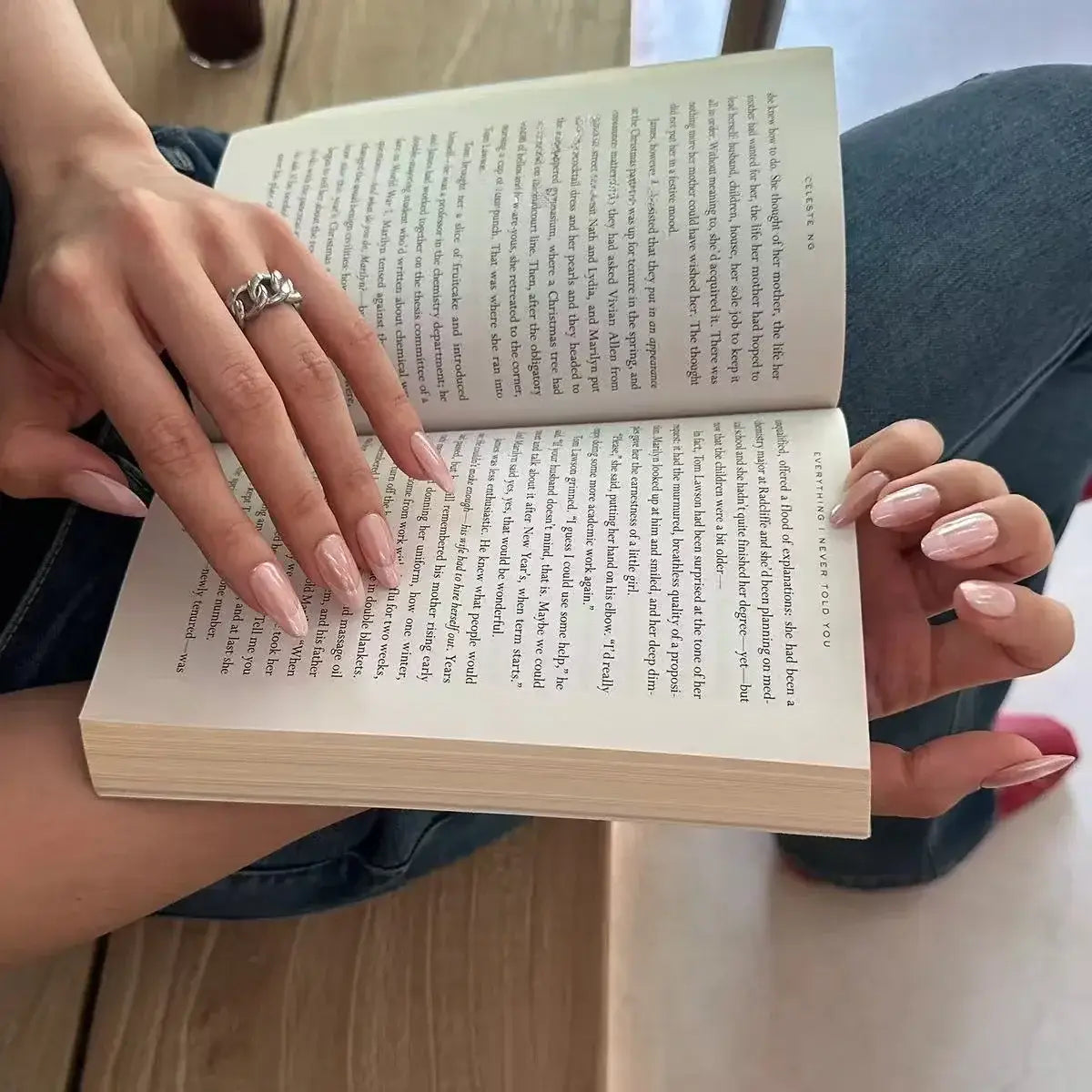 Rosé Chrome press-on nails on hand