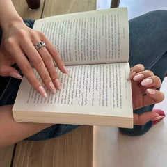 Rosé Chrome press-on nails on hand
