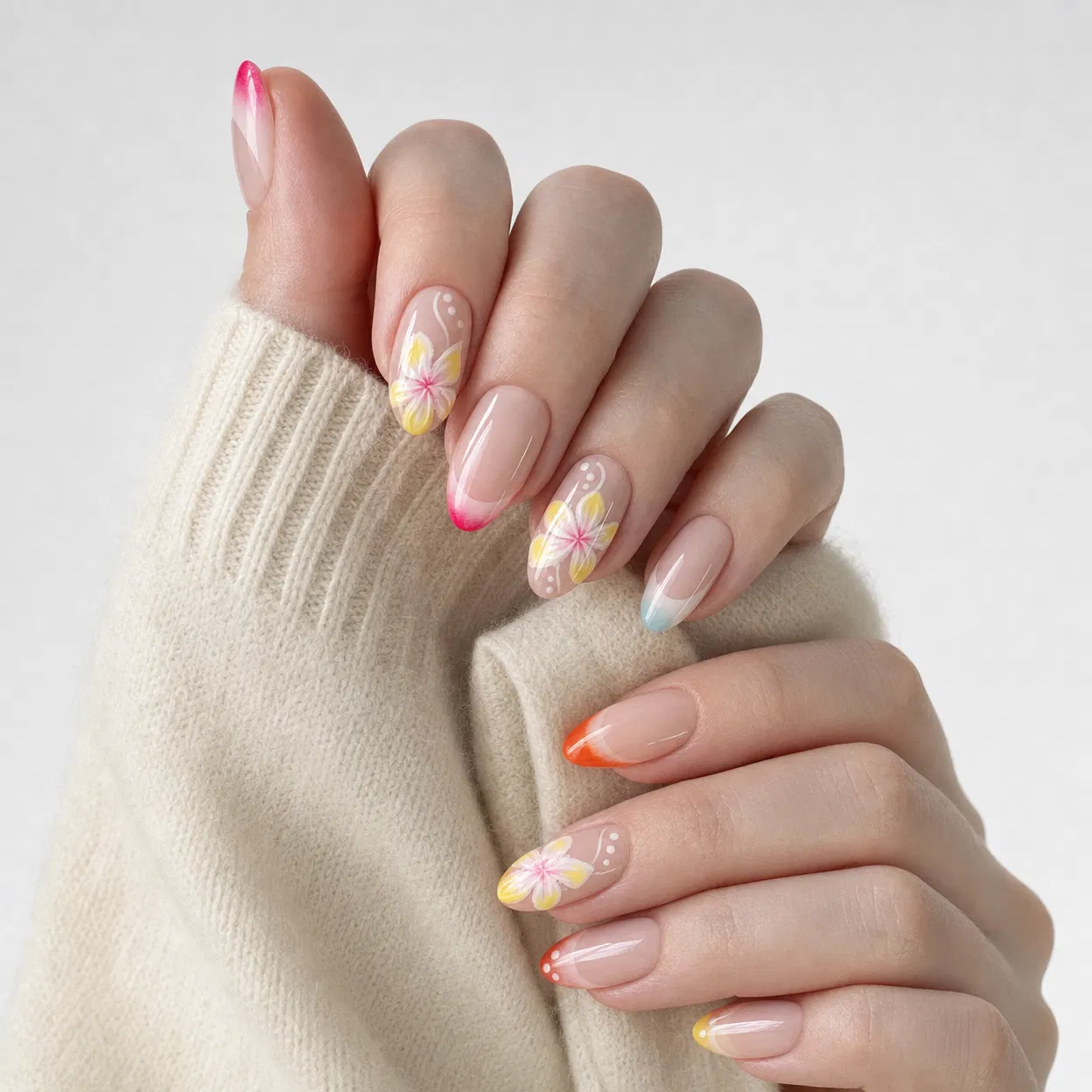 Close-up of hands with floral nail art on a light background