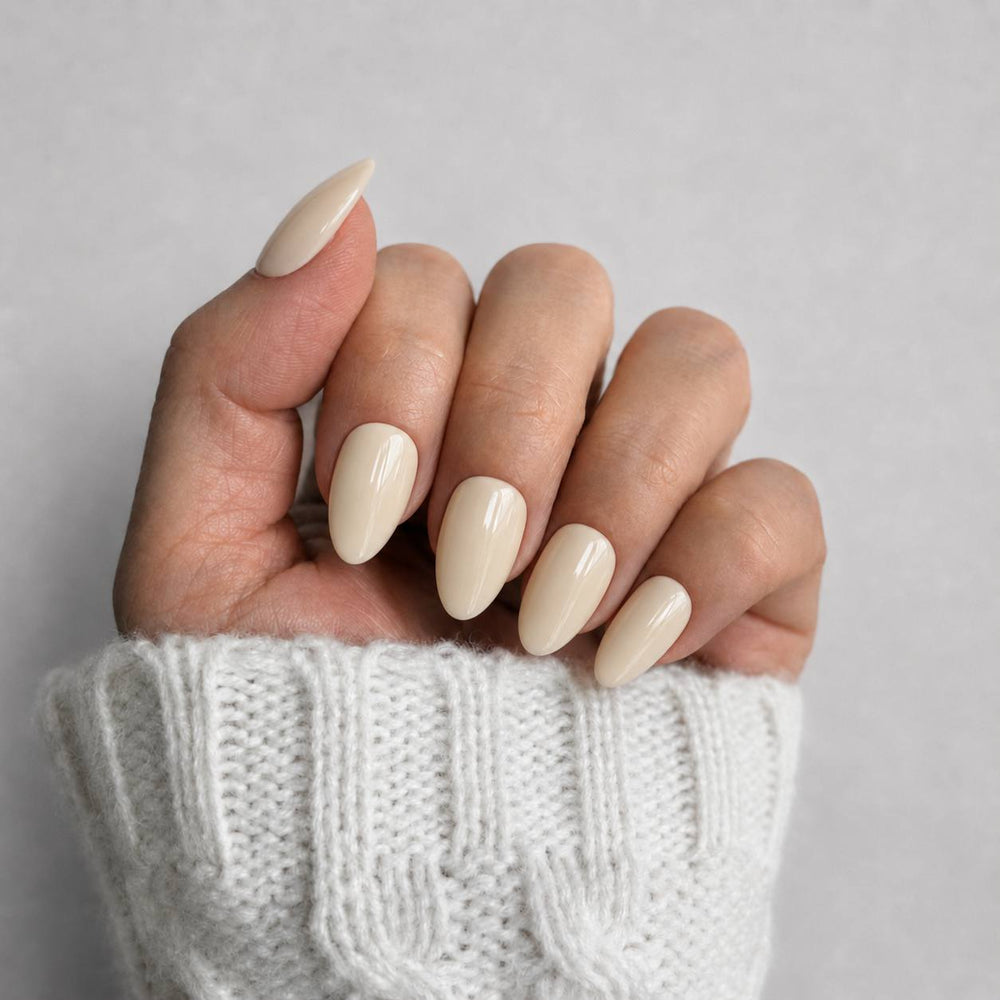 Nailora Vanilla Ivory glossy short almond press-on nails in a creamy neutral shade with a reusable salon-quality finish for everyday and bridal wear.