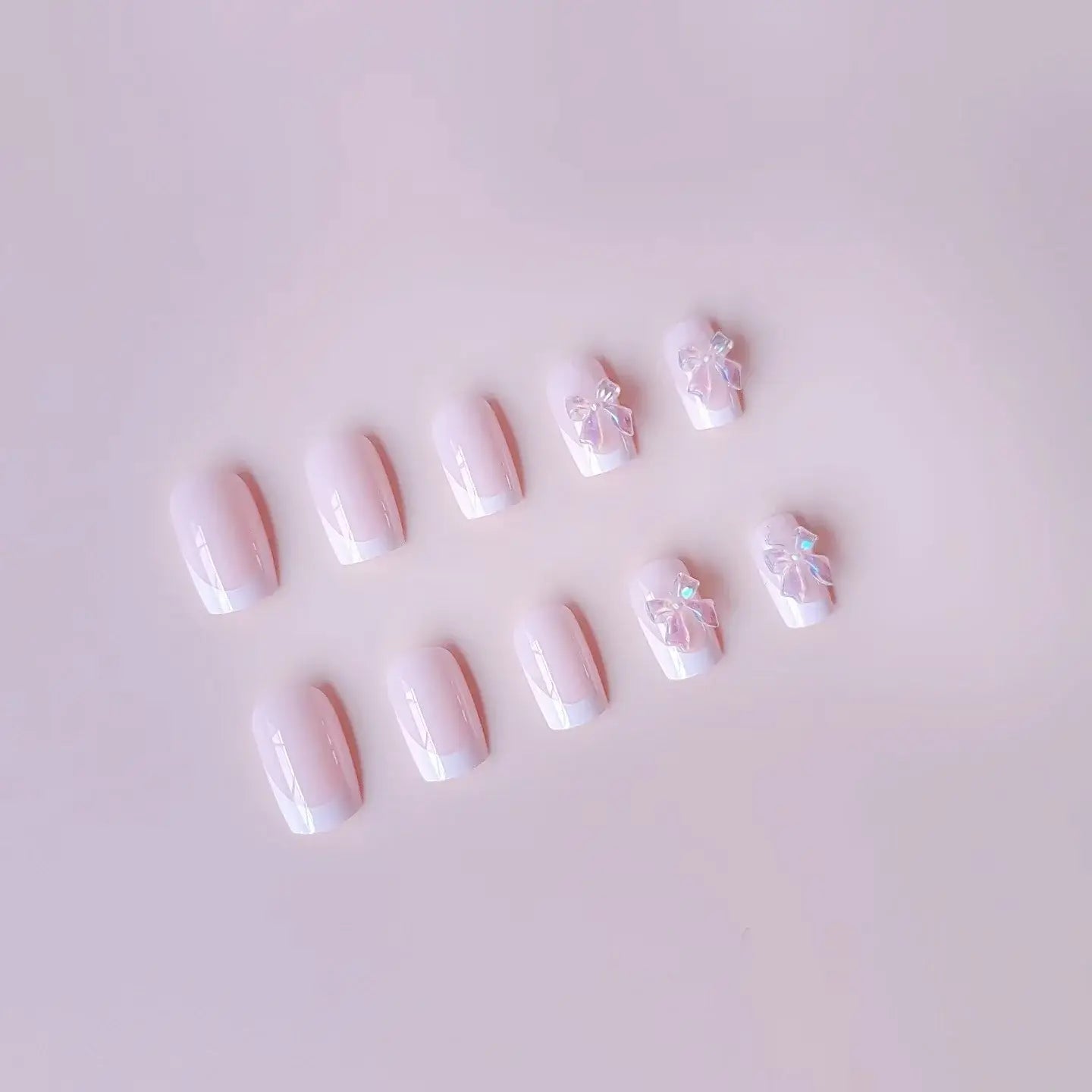 Pink Satin press-on nails applied